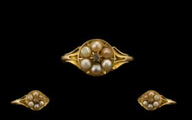 An Early 19thC 18ct Gold Pearl Ring set with a central rose cut diamond between 6 split seed pearls,