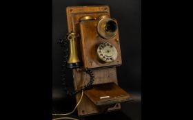 Vintage Wall Telephone in oak wood with side receiver and twin bells to top.