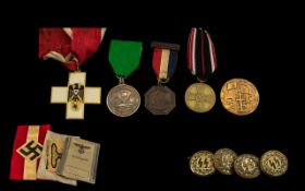 A Small Mixed Lot Of German Nazi Memorabilia to include two arm bands, cloth badge, SS cufflinks,