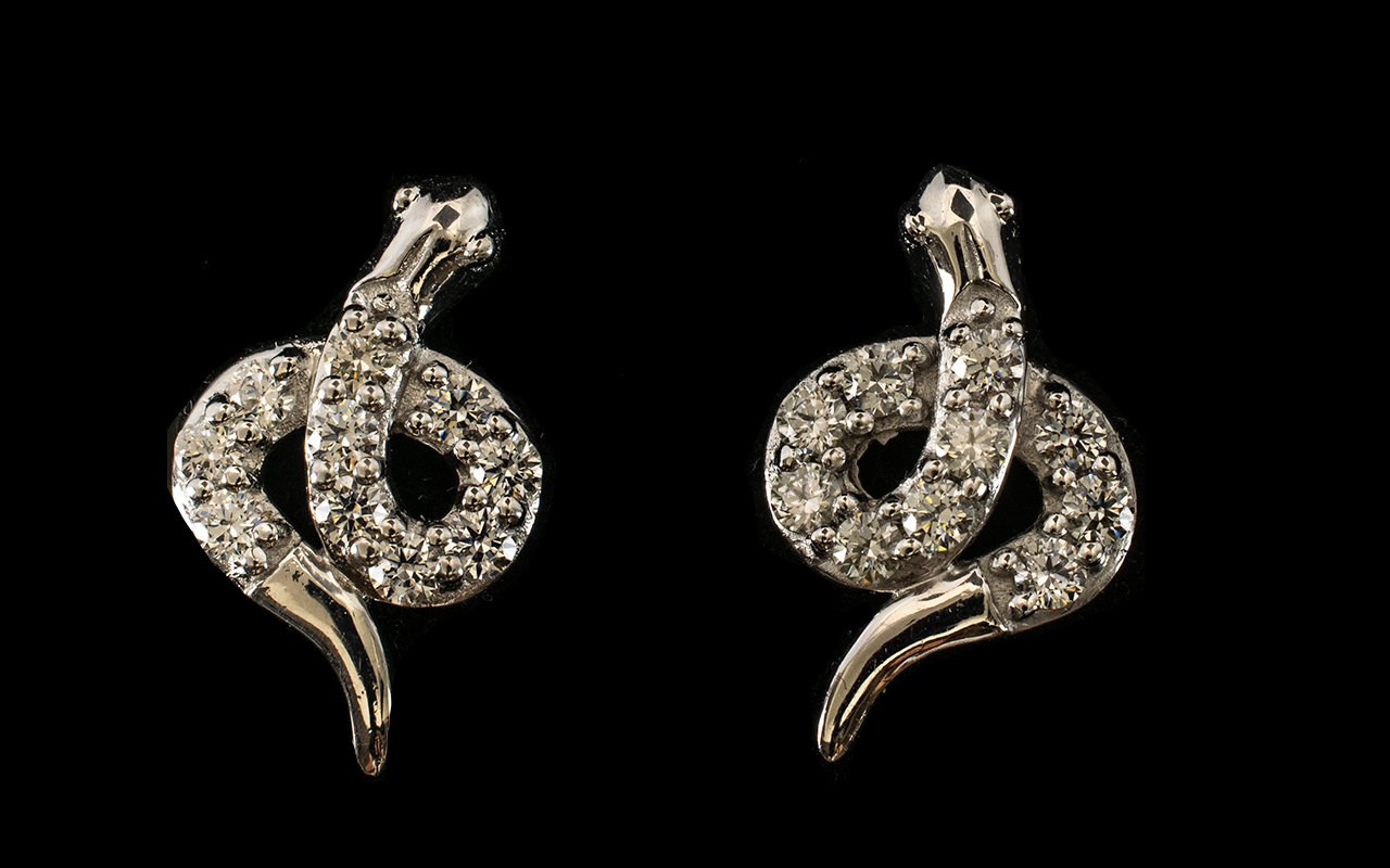 Swarovski Zirconia Set Serpent Earrings, each earring in the form of a coiled serpent set with round