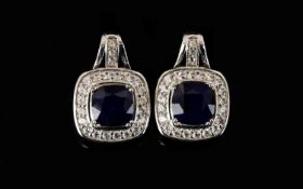 Sapphire and Natural White Zircon Drop Earrings, with ruby accents; each earring comprising a square