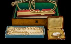 A Victorian Maple Wood Stationery Box containing a small collection of faux pearl necklaces.