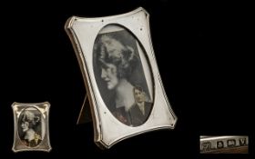 An Early 20thC Silver Mounted Photo Frame of shaped form, oak backed with strut. Fully hallmarked