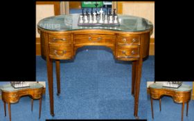 An Edwardian Kidney Shaped Writing Desk complete with a green leather inset top.