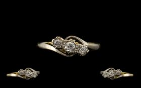 18ct Three Stone Diamond Ring set with three round cut diamonds on a twist, fully hallmarked. Ring