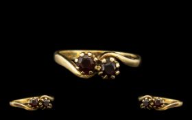 A 9ct Gold Dress Ring set with two garnets. Fully hallmarked. Ring size K.5. Weight 2.2 grams.