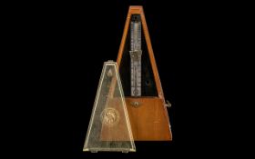 A Mid 20thC Mahogany Cased Metronome. 10 inches in height.