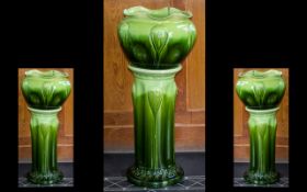 A Large Art Nouveau Green Glazed Jardiniere and Stand of sinuous form. Unmarked possibly Bretby.