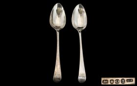 Two Georgian Silver Table Spoons both hallmarked for London O- 1809. Makers mark TN. Length 8.5