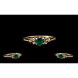 Ladies Attractive 9ct Gold Diamond & Emerald Set Dress Ring. The central emerald with diamond set