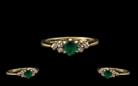 Ladies Attractive 9ct Gold Diamond & Emerald Set Dress Ring. The central emerald with diamond set