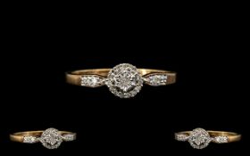 A 9ct Gold - Attractive Diamond Set Cluster Ring - Flower head Design. The Central Diamond