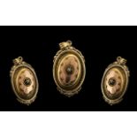 A Victorian Gilt Metal Hinged Locket with embossed oval locket, the hinged front with glazed