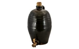 A Stoneware Green Glazed Cider Barrel with wooden stopper and tap. Height 148 inches.