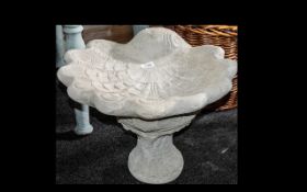 Shell Bird Bath - a large shell shaped bird bath on a decorative base.