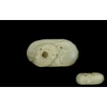 A Chinese Carved Mutton Fat Jade Pebble worked with an exotic feature. Approx 3 by 1.5 inches.