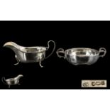 A Silver Twin Handled Porringer of Plain form with a molded edge and scroll handles.