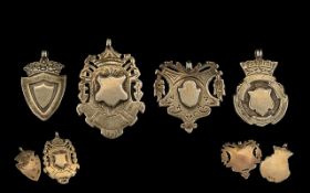 A Collection of Four Silver Fobs / Medals featuring un engraved crests / shields.