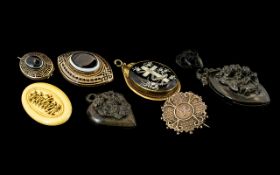 A Small Mixed Lot of Victorian Brooches mostly base metal to include mourning brooch set with banded