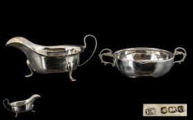 A Silver Twin Handled Porringer of Plain form with a molded edge and scroll handles. Hallmarked