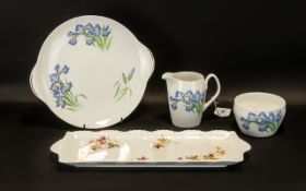 Collection of Shelley Vintage 'Blue Iris' Porcelain comprising a milk jug, sugar bowl and cake