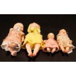 Four Various Plastic and Celluloid Baby Dolls, all in knitted clothes; sizes from 10.25 inches (26