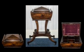 A Victorian Teapoy in rosewood. The top opens to reveal a sectioned interior and two mixing bowls