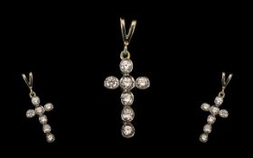 A White Gold Diamond Cross with 7 round brilliant cut diamonds in a rub over setting. Est diamond