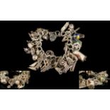 A Vintage Silver Bracelet Loaded with Approx 40 Silver Charms - Both Bracelet and Charms.