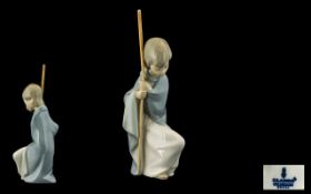 Lladro Nativity Figure of a Shepherd Boy, kneeling down with a crook in hand. 7 inches in height.