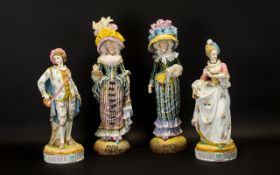 Four Decorative Bisque Figures brightly painted in bold colours. Comprising of a pair of Parisian