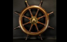 An Early 20thC Oak Ships Wheel with brass mounts and banding, marked to the centre 'Mactaggart Scott