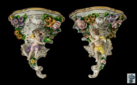 Pair of German Sitzendorf Porcelain Wall Pockets with cherub and flower petal decoration of