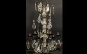 A French Six Branch Chandelier Light Fitting with iron arms and crystal droplets.