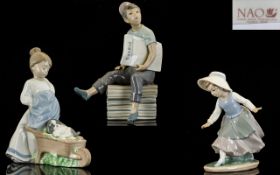 Nao by Lladro Collection of Three Figures comprising 1. Newspaper Boy 1972. 9.5 inches. 23.75 cms.