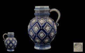 Decorative Merkelbach & Wick Pottery Pitcher. Attractive cobalt blue ground with raised decorative