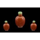 Chinese Pink Speckled Glass Snuff Bottle, with jade stopper, Plain Form Height 2.5 Inches.