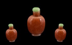 Chinese Pink Speckled Glass Snuff Bottle, with jade stopper, Plain Form Height 2.5 Inches.