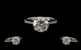 18ct White Gold - Attractive Single Stone Diamond Set Ring with Diamond Shoulders. Est Diamond