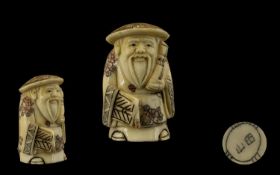 Oriental Carved Netsuke depicting a figural Scholar. Approx 2.5 inches in height.