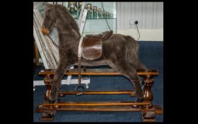 A 1915 Mrs Beeton Silver Cross Velour Covered Rocking Horse with a H swing crane.