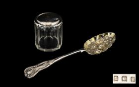 Two Silver Items to include a Fruit Spoon, the bowl decorated with pineapple, melon and bananas.