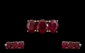 Ruby Three Stone Ring, a trilogy of rubies of good colour, totalling 5.5cts, set in a row, in