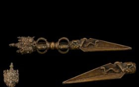 Tibetan Bronze Phurba The triform blade clasped by a dragon head,