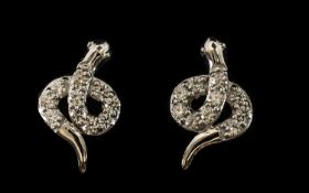 Swarovski Zirconia Set Serpent Earrings, each earring in the form of a coiled serpent set with round