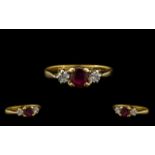 Ladies 18ct Gold 3 Stone Ruby & Diamond Ring. Pleasing design. Ring size J-K. Marked 750 - 18ct.