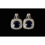 Sapphire and Natural White Zircon Drop Earrings, with ruby accents; each earring comprising a square