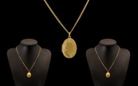 14ct Gold - Oval Shaped Hinged Locket with Attached 14ct Gold Chain,