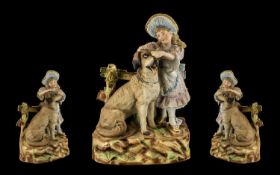 A German Heubach Late 19thC Bisque Figure Group depicting a baby piano girl with a large dog.