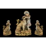 A German Heubach Late 19thC Bisque Figure Group depicting a baby piano girl with a large dog.